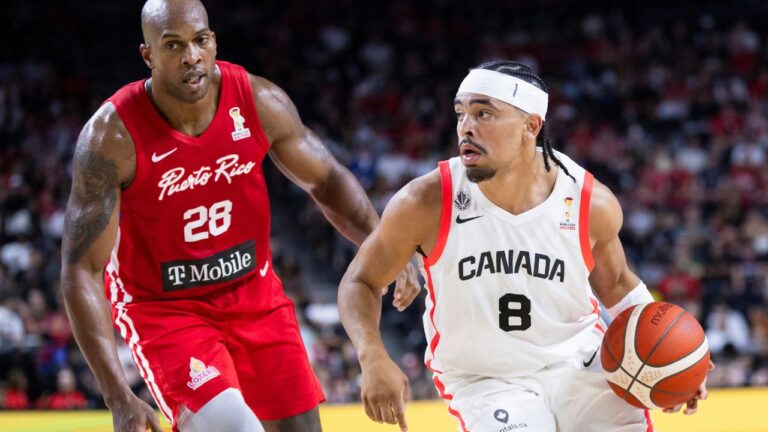 Canada's Ryan Nembhard goes past Puerto Rico's Ismael Romero during FIBA World Cup qualification action in Hamilton on Friday, July 3, 2026. (Nick Iwanyshyn/CP)