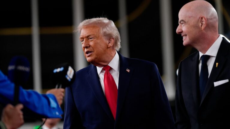 Donald Trump speaks to reporters as FIFA President Gianni Infantino watches ahead of the draw for the World Cup at the Kennedy Centre on Friday, Dec. 5, 2025, in Washington. (Julia Demaree Nikhinson/AP)