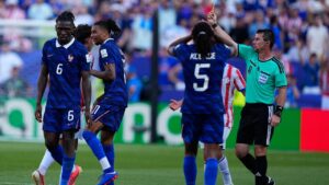 Referee Ilgiz Tantashev shows a yellow card to France's Michael Olise during the Round of 16 match against Paraguay in Philadelphia on Saturday, July 4, 2026. (Petr David Josek/AP)