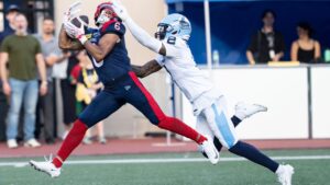 Montreal Alouettes' Tyson Philpot catches a touchdown against the Toronto Argonauts' Tarvarus McFadden during CFL action in Montreal on Friday, June 12, 2026. (Christinne Muschi/CP)