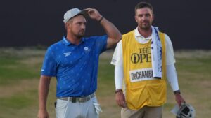 Bryson DeChambeau of the United States with his caddie Greg Bodine on the 18th green after he completed his second round during the second day of the British Open Golf championships at Royal Birkdale golf club, in Southport, England, Friday, July 17, 2026. (Jon Super/AP)