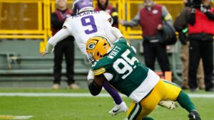 J.J. McCarthy is sacked by Devonte Wyatt during the second half of a game Sunday, Nov. 23, 2025. (Mike Roemer/AP)