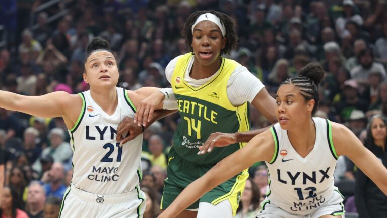 Seattle Storm centre Dominique Malonga is defended by Minnesota Lynx forward Nia Coffey, right, and guard Kayla McBride during the first half of a WNBA game Monday, July 20, 2026, in Seattle. (Dean Rutz/The Seattle Times via AP)