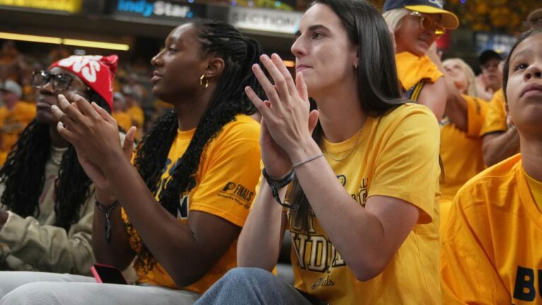 Indiana Fever's Caitlin Clark and Aliyah Boston watch during Game 3 of the NBA Finals between the Indiana Pacers and the Oklahoma City Thunder, Wednesday, June 11, 2025, in Indianapolis. (Michael Conroy/AP)