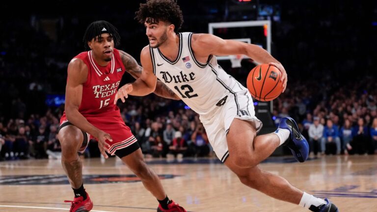 Cameron Boozer (12) drives past Texas Tech forward JT Toppin (15) during the first half of a game, Dec. 20, 2025, in New York. (Yuki Iwamura/AP)