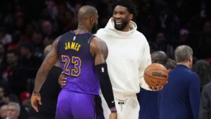 Joel Embiid and LeBron James talk during the first half of a game, Tuesday, Jan. 28, 2025, in Philadelphia. (Matt Slocum/AP)