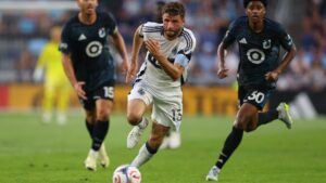 Vancouver Whitecaps FC midfield Thomas Müller (13) brings the ball up the field during the first half of an MLS soccer match on Saturday, July 25, 2026, in St. Paul, Minn. (AP Photo/Adam Bettcher)