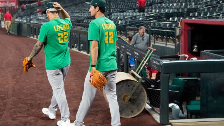 Athletics' Tommy White, left, and Alika Williams wear a Lasko No. 22 t-shirt in honour of injured prospect Ryan Lasko prior to a game against the Arizona Diamondbacks, Wednesday, July 22, 2026, in Phoenix. (Ross D. Franklin/AP)