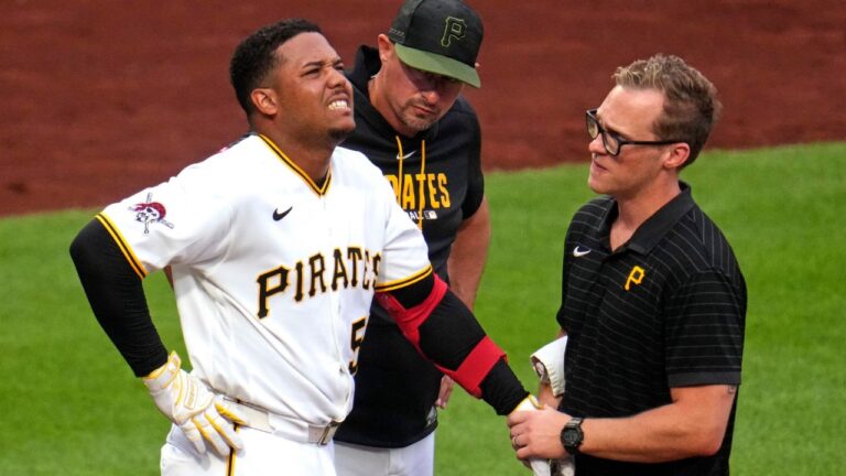 Esmerlyn Valdez is examined by a team trainer after being hit by a pitch during the fourth inning of a game in Pittsburgh, Monday, July 27, 2026. (Gene J. Puskar/AP)