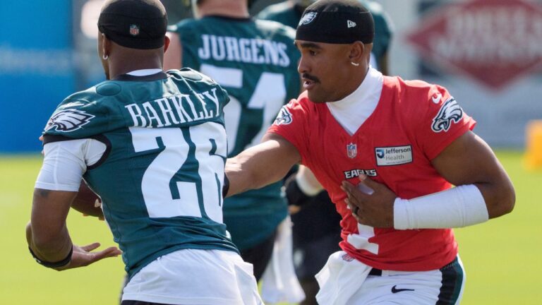 Philadelphia Eagles quarterback Jalen Hurts hands the ball off to running back Saquon Barkley during practice at the team's training camp in Philadelphia, Wednesday, July 29, 2026. (Chris Szagola/AP)