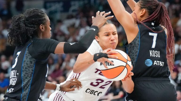 Toronto Tempo's Tima Pouye tries to drive between Minnesota Lynx's Lani White and Anastasiia Olairi Kosu during action in Toronto on Thursday, July 30, 2026. (Chris Young/CP)