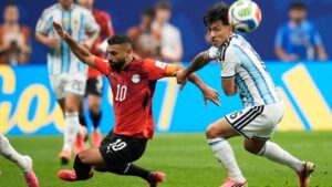 Egypt's Mohamed Salah (10) battles for the ball with Argentina's Lisandro Martinez (6) during the World Cup round of 16 match between Argentina and Egypt in Atlanta, Tuesday, July 7, 2026. (Mike Stewart/AP)