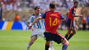 Argentina's Lionel Messi (10) controls the ball in front of Spain's Aymeric Laporte (14) during the World Cup final soccer match between Spain and Argentina. (Abbie Parr/AP)