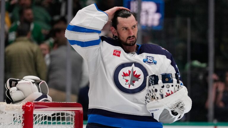 Winnipeg Jets goaltender Connor Hellebuyck stands by the net during a time out from play against the Dallas Stars in the first period of an NHL hockey game Thursday, April 2, 2026, in Dallas. (Tony Gutierrez/AP)