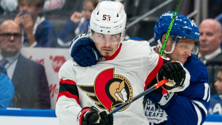 Toronto Maple Leafs centre Max Domi (11) grabs Ottawa Senators' Xavier Bourgault (53) during second period NHL pre-season hockey action in Toronto, Sunday, Sept. 22, 2024. THE CANADIAN PRESS/Paige Taylor White