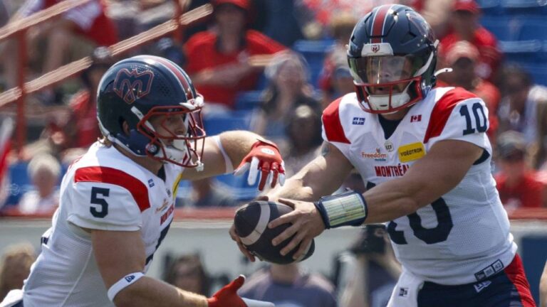 Montreal Alouettes quarterback Davis Alexander, right, hands the football off to Travis Theis during first half CFL football action against the Calgary Stampeders, in Calgary, Saturday, July 18, 2026. (Jeff McIntosh/CP)