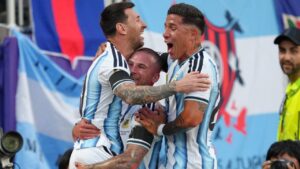 Argentina's Alexis Mac Allister, center, celebrates after scoring his side's opening goal with teammates Argentina's Lionel Messi, left, and Argentina's Enzo Fernandez during the World Cup quarterfinal soccer match between Argentina and Switzerland in Kansas City, Mo., Saturday, July 11, 2026. (Ed Zurga/AP)