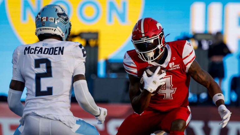 Toronto Argonauts' Tarvarus McFadden, left, defends against Calgary Stampeders' Tevin Jones during second half CFL football action in Calgary, Thursday, July 2, 2026. (Jeff McIntosh/THE CANADIAN PRESS)