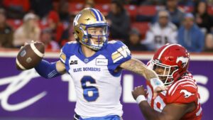 Calgary Stampeders' T.J Rayam (99) closes in on Winnipeg Blue Bombers quarterback Dru Brown (6) as he looks for the pass during second half CFL football action in Calgary, Alta., Friday, Aug. 18, 2023. (Larry MacDougal/CP Photo)