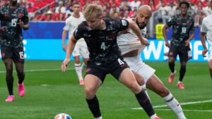 Canada's Luc de Fougerolles, front, and Morocco's Noussair Mazraoui battle for the ball during the World Cup round of 16 soccer match in Houston, Saturday, July 4, 2026. (David J. Phillip/AP)