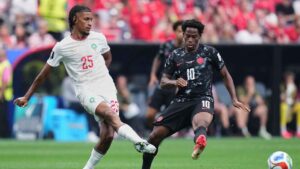Morocco's Redouane Halhal, left, and Canada's Jonathan David, fight for the ball during the World Cup round of 16 soccer match between Canada and Morocco, in Houston. (Karen Warren/AP)