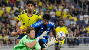 CF Montreal goalkeeper Sebastian Breza, centre, catches the ball past Nashville SC forward Ahmed Qasim, left, and CF Montreal defender Efrai­n Morales, right, during the second half of an MLS soccer match Wednesday, July 22, 2026, in Nashville, Tenn. (George Walker IV/CP)