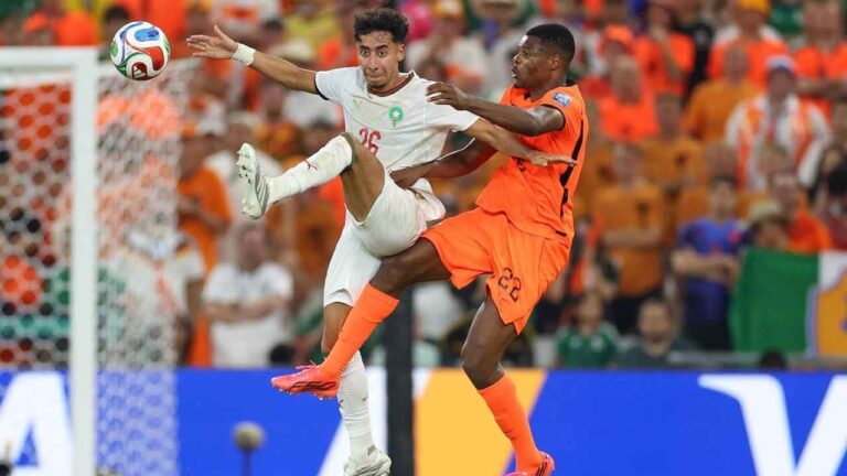 Morocco's Anass Salah Eddine (26) and Netherlands' Denzel Dumfries (22) jump for control of the ball during the World Cup round of 32 soccer match between the Netherlands and Morocco. (Addison Simmons/AP)