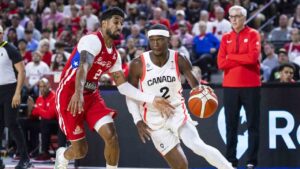 Canada's Shai Gilgeous-Alexander (2) drives the ball past Puerto Rico's Jezreel De Jesus (2) during first half FIBA World Cup qualification action in Hamilton on Friday, July 3, 2026. (Nick Iwanyshyn/CP)