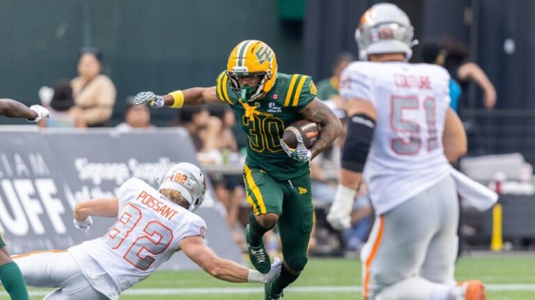 Edmonton Elks' Tyrell Ford (30) returns an interception and breaks a tackle against BC Lions' Kieran Poissant (82) during first half CFL football action in Edmonton on Friday, July 17, 2026. (Timothy Matwey/CP)