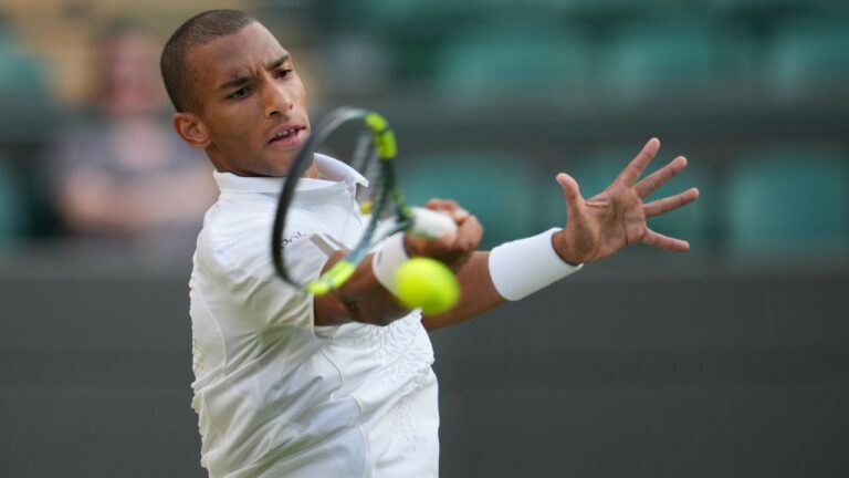 Felix Auger-Aliassime of Canada plays a forehand against Dino Prizmic of Croatia in their second round men's singles match at the Wimbledon Tennis Championships in London, Wednesday, July 1, 2026. (Kin Cheung/AP)