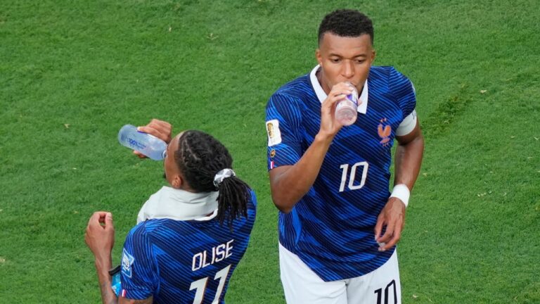 France's Kylian Mbappe (10) and France's Michael Olise (11) drink during a hydration break during the World Cup round of 32 soccer match between France and Sweden in East Rutherford, N.J., near New York, Tuesday, June 30, 2026. (Yuki Iwamura/AP)