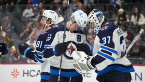 Winnipeg Jets centre Mark Scheifele (55) congratulates goaltender Connor Hellebuyck (37) after defeating the Colorado Avalanche in an NHL hockey game Saturday, March 28, 2026, in Denver. (David Zalubowski/AP)