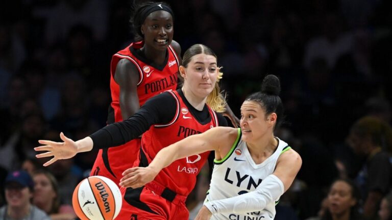 Minnesota Lynx guard Kayla McBride (21) passes the ball as she's defended by Portland Fire centre Luisa Geiselsoder (15) in the first quarter of a WNBA basketball game on Saturday, July 18, 2026, in Minneapolis, Minn. (Aaron Lavinsky/Minnesota Star Tribune via AP)