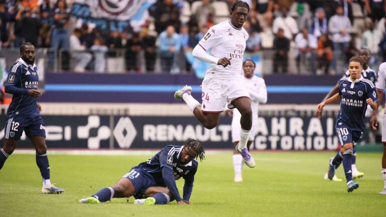 Metz's Brian Madjo, centre, and Paris FC's Jean-Philippe Krasso, bottom, in action during the League One soccer match between Paris FC and Metz at the Jean-Bouin stadium. (Thomas Padilla/AP)