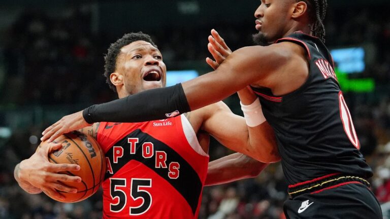 Toronto Raptors guard Alijah Martin (55) clutches the ball as he fends off Philadelphia 76ers guard Tyrese Maxey (0) during first half NBA basketball action in Toronto, Sunday, Jan. 11, 2026. (Frank Gunn/CP)