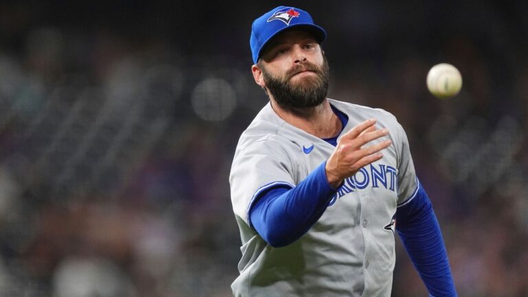 Toronto Blue Jays relief pitcher Tommy Nance tosses the ball to first base to put out Colorado Rockies' Tyler Freeman to end in a baseball game Tuesday, Aug. 5, 2025, in Denver. (David Zalubowski/AP)