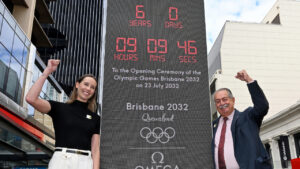 Australian Olympian Emma McKeon, left, and Brisbane 2032 Organising Committee President Andrew Liveris pose at the unveiling of the count-down clock marking six years until the Brisbane 2032 Olympics, in Brisbane, Australia, Thursday, July 23, 2026. (Darren England/AAP Image via AP)