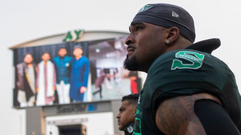 Saskatchewan Roughriders defensive lineman Devin Adams (95) reacts to a memorial video tribute to Roughrider linebacker Jayden Dalke, and Bhishma Rajyaguru, who were killed in a highway crash, prior to first half CFL football action against the Edmonton Elks in Regina on Thursday, July 23, 2026. (Kayle Neis/THE CANADIAN PRESS)