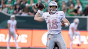 BC Lions quarterback Nathan Rourke (12) lines up a pass during second half CFL football action in Regina on Saturday, June 13, 2026. (Kayle Neis/CP)