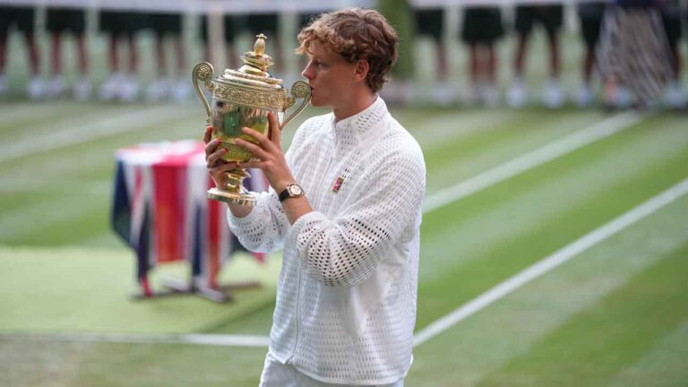 Jannik Sinner of Italy kisses his trophy after winning against Alexander Zverev of Germany in the men's singles final at Wimbledon Tennis Championships. (Kirsty Wigglesworth/AP)
