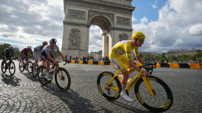 Slovenia's Tadej Pogacar, wearing the overall leader's yellow jersey, rides in front of the Arc de Triomphe during the last stage of the Tour de France cycling race with start and finish in Paris, Sunday, July 26, 2026. (Mosa'ab Elshamy/AP)