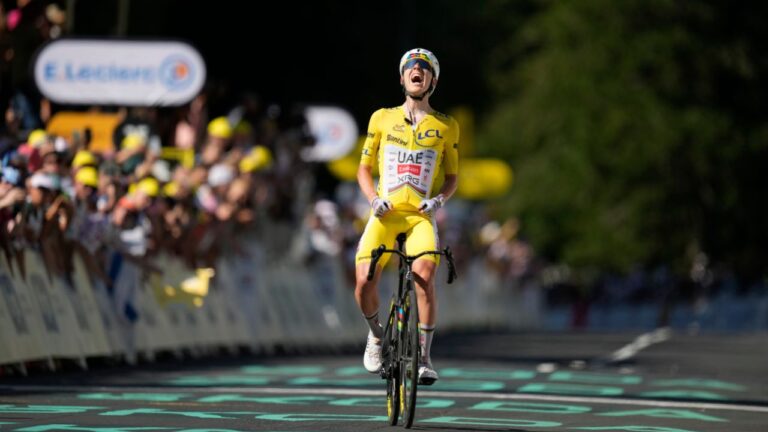 Slovenia's Tadej Pogacar, wearing the overall leader's yellow jersey, celebrates after winning the tenth stage of the Tour de France cycling race with start in Aurillac and finish in Le Lioran, France, Tuesday, July 14, 2026. (Mosa'ab Elshamy/AP)