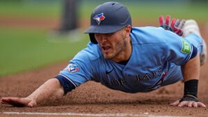 Toronto Blue Jays' Daulton Varsho gets back to first base safely during the fifth inning of a baseball game against the San Diego Padres Sunday, July 12, 2026, in San Diego. (Gregory Bull/AP Photo)
