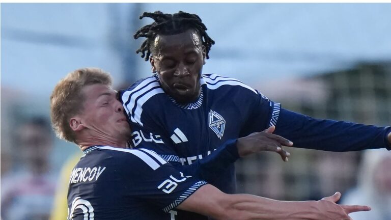 Vancouver Whitecaps' Mihail Gherasimencov, left, and J.C. Ngando collide during the first half of a Canadian Championship quarterfinal soccer match against Cavalry FC, in Burnaby, B.C., on Wednesday, July 8, 2026. (Darryl Dyck/THE CANADIAN PRESS)