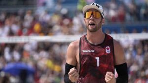 Canada's Samuel Schachter celebrates in a beach volleyball match against Austria at the 2024 Summer Olympics, Friday, Aug. 2, 2024, in Paris, France. (Robert F. Bukaty/AP)