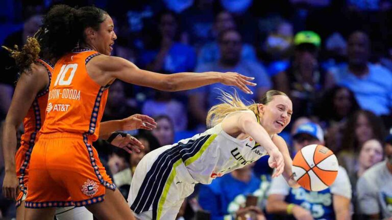 Dallas Wings guard Paige Bueckers, right, makes a pas as Connecticut Sun's Olivia Nelson-Ododa (10) defends during the first half of a WNBA basketball game in Arlington, Texas, Sunday, Aug. 2, 2026. (Tony Gutierrez/AP)