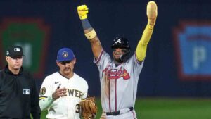 Atlanta Braves' Ronald Acuña Jr., right, celebrates next to Milwaukee Brewers shortstop Joey Ortiz (3) after stealing second base during the fifth inning of the Little League Classic baseball game in Williamsport, Pa., Sunday, Aug. 23, 2026. (Gene J. Puskar/AP)