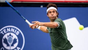 Alexis Galarneau of Canada returns the ball during his first round match against Vit Kopriva, of Czechia, on day two of the National Bank Open tennis tournament in Montreal on Monday August 3, 2026. (Christopher Katsarov/CP)