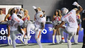 BC Lions running back James Butler (20) celebrates his first half touchdown with teammates Jermaine Jackson (84) and Keon Hatcher Sr. (4) during CFL football action against the Ottawa Redblacks in Ottawa, Sunday, Aug. 30, 2026. (Chris Tanouye/CP)