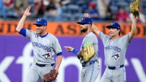 Toronto Blue Jays' Myles Straw, from left, Nathan Lukes and Brett Bateman celebrate after the Toronto Blue Jays won a baseball game against the Philadelphia Phillies early Saturday, Aug. 8, 2026, in Philadelphia. (Matt Slocum/AP)
